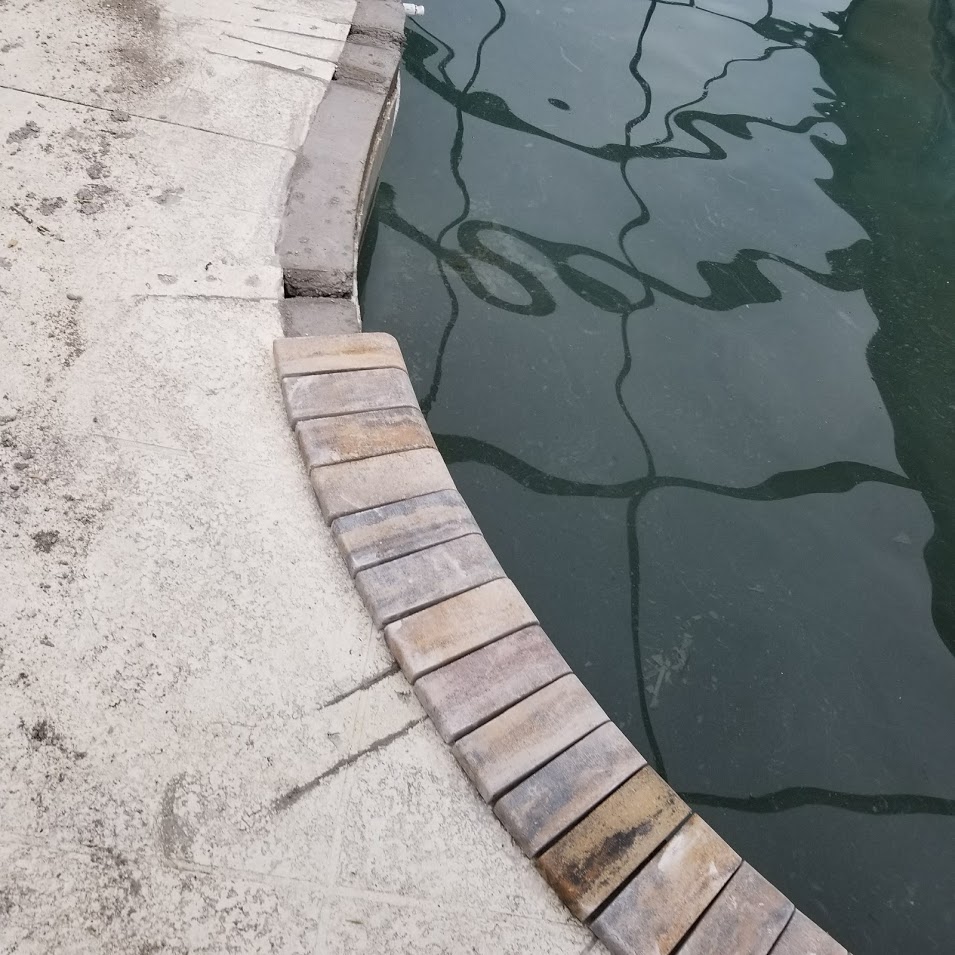 close up of pool with bricks laid