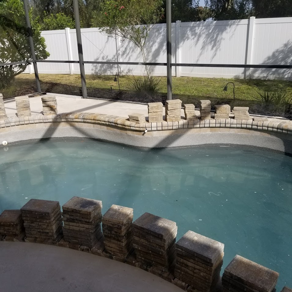 wider view of pool with stacks of bricks | home renovation in Sarasota FL