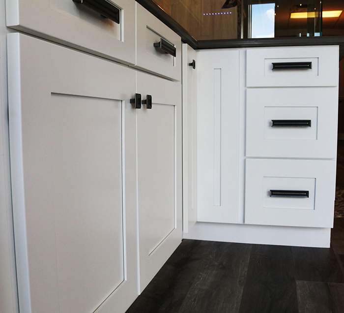 modern white cabinets and drawers with black hardware